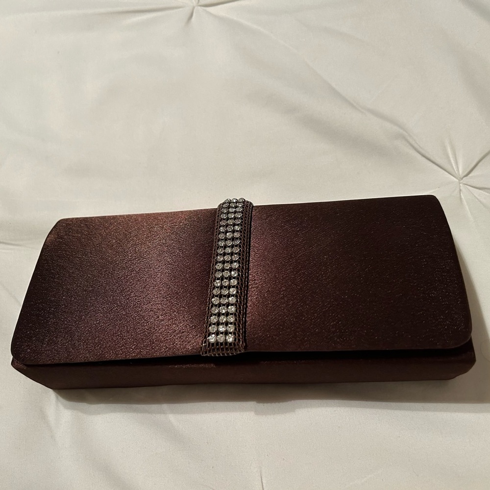 Brown satin-feel clutch with rhinestone embellishment.